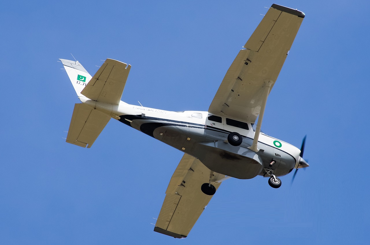 Cessna 206 flying above clouds